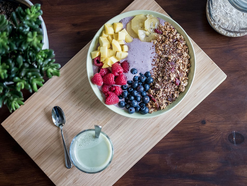 bowl of yogurt with oats and fruit topping